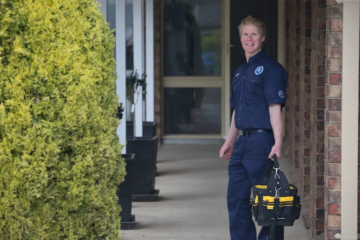 A Fix-It Right plumber at a customer's front door