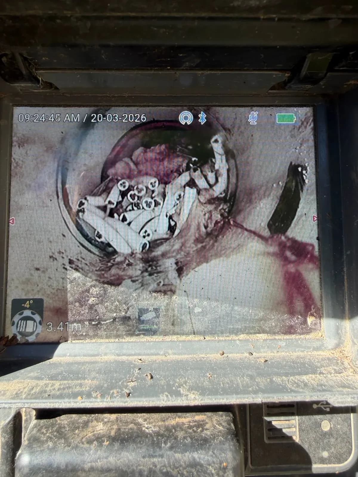 Drain camera view of plastic objects lodged in the sewer
