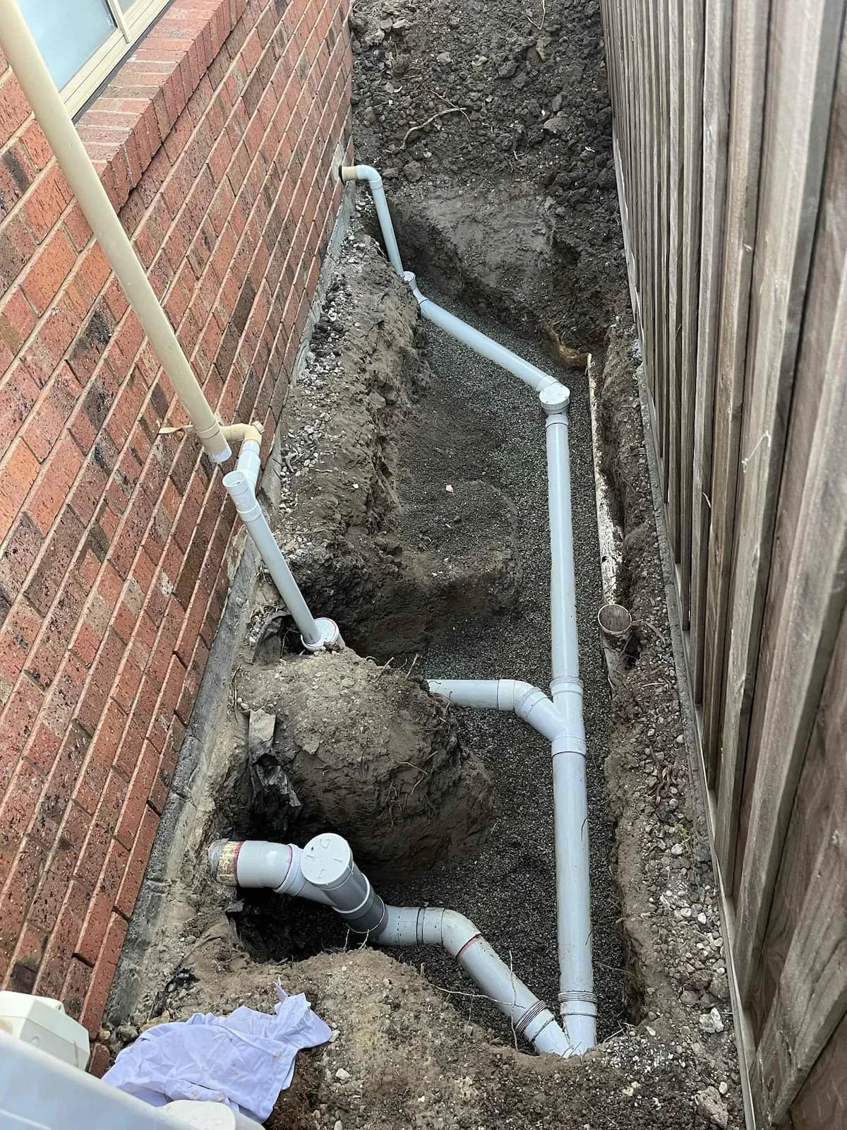 Broken sewer section replaced with new PVC pipe