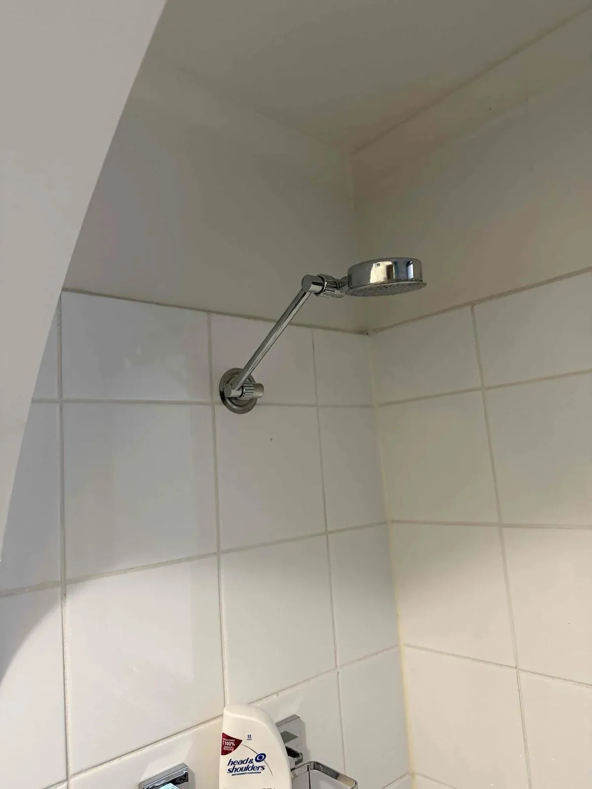 Old shower head before the upgrade