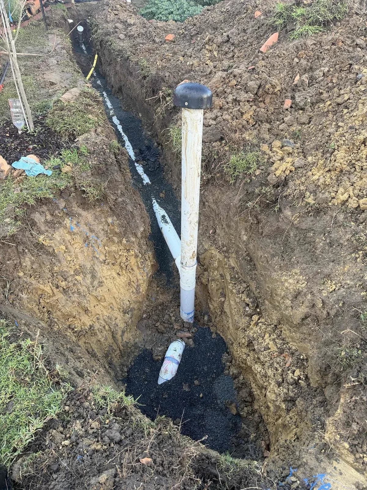 New sewer line laid along the side of the house