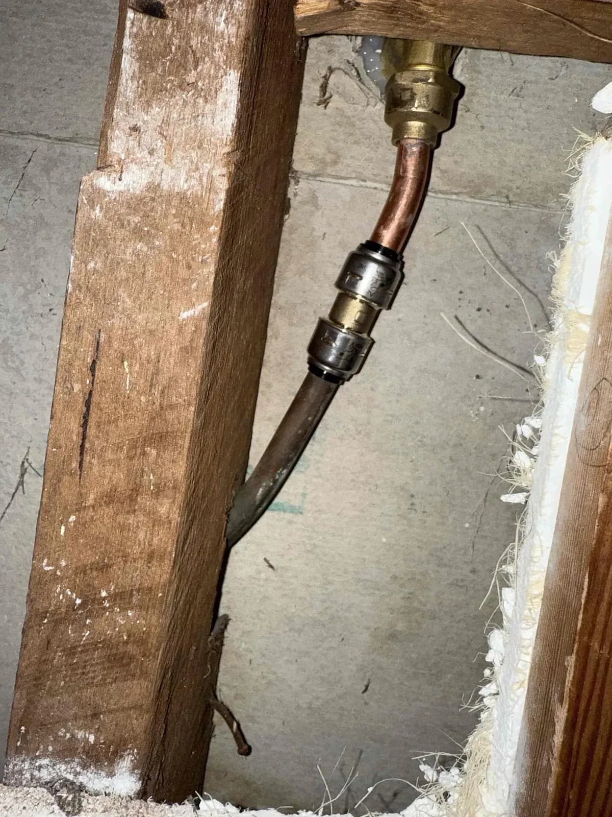 Shower pipework behind the opened wall