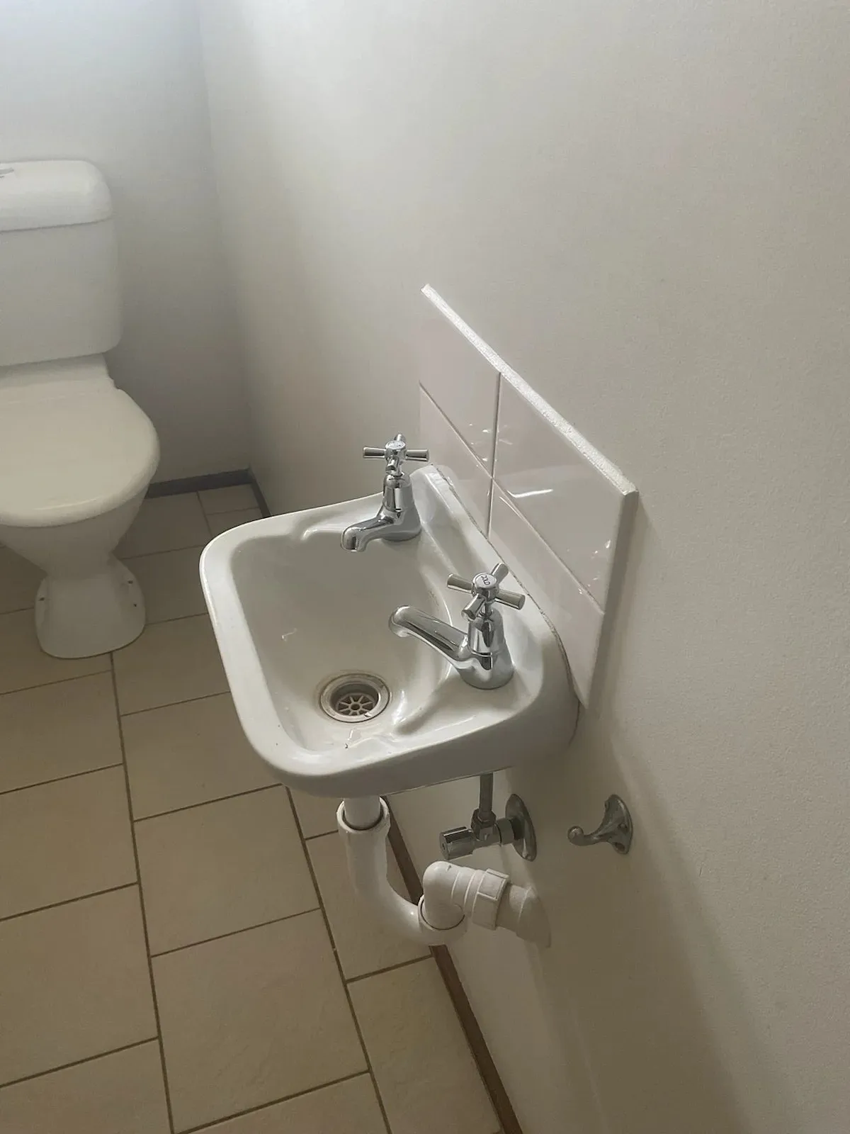 Toilet and small basin after the repair
