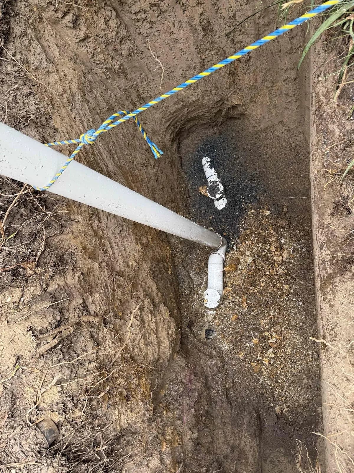 Drain pipework exposed in a deep trench