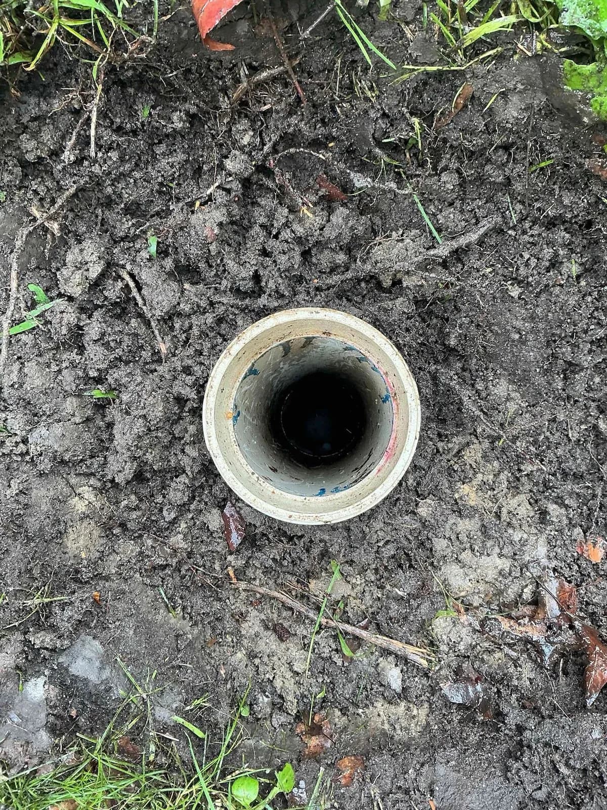 Drain inspection opening dug out in the yard