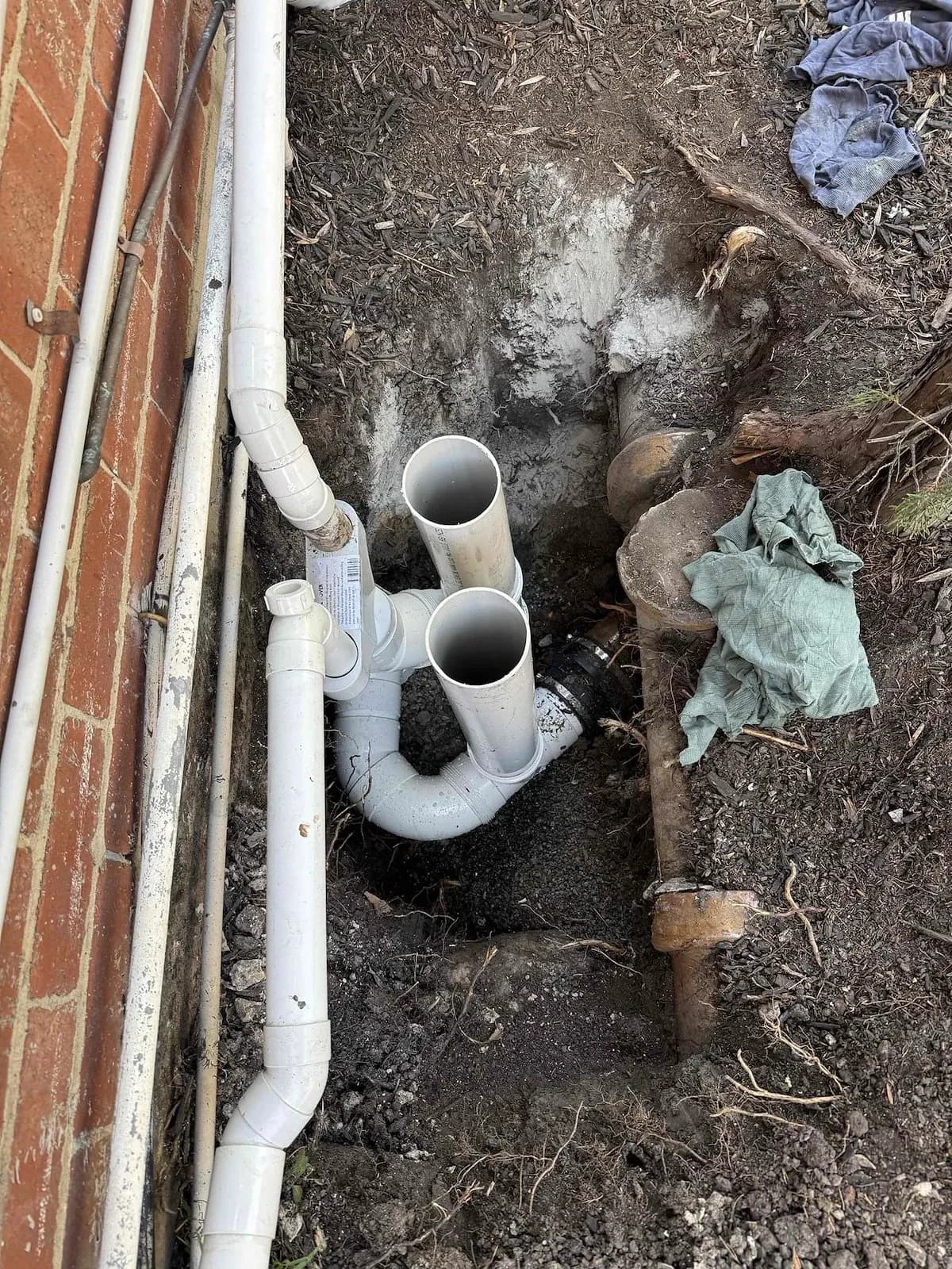 New PVC drain connections beside the house