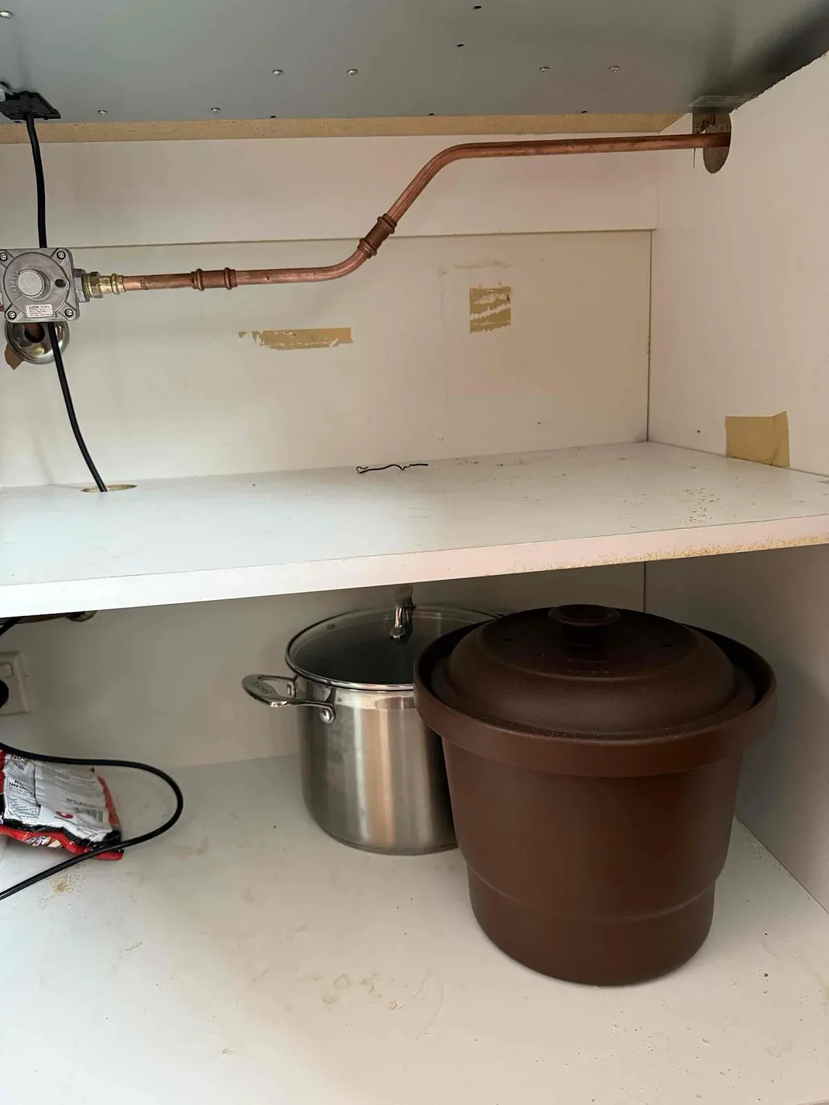 Gas line and isolation valve inside the kitchen cupboard
