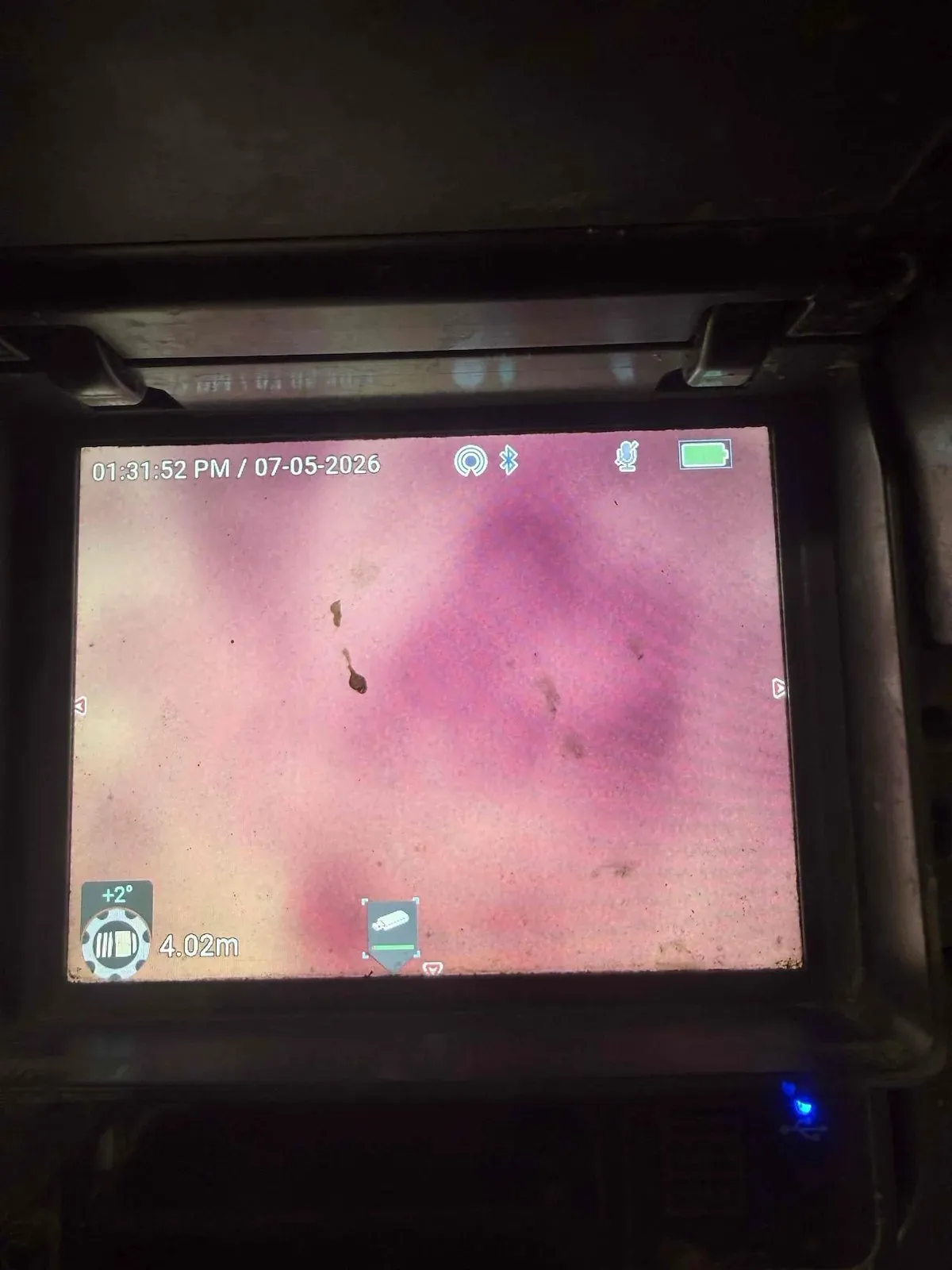 Drain camera screen inspecting the toilet drain
