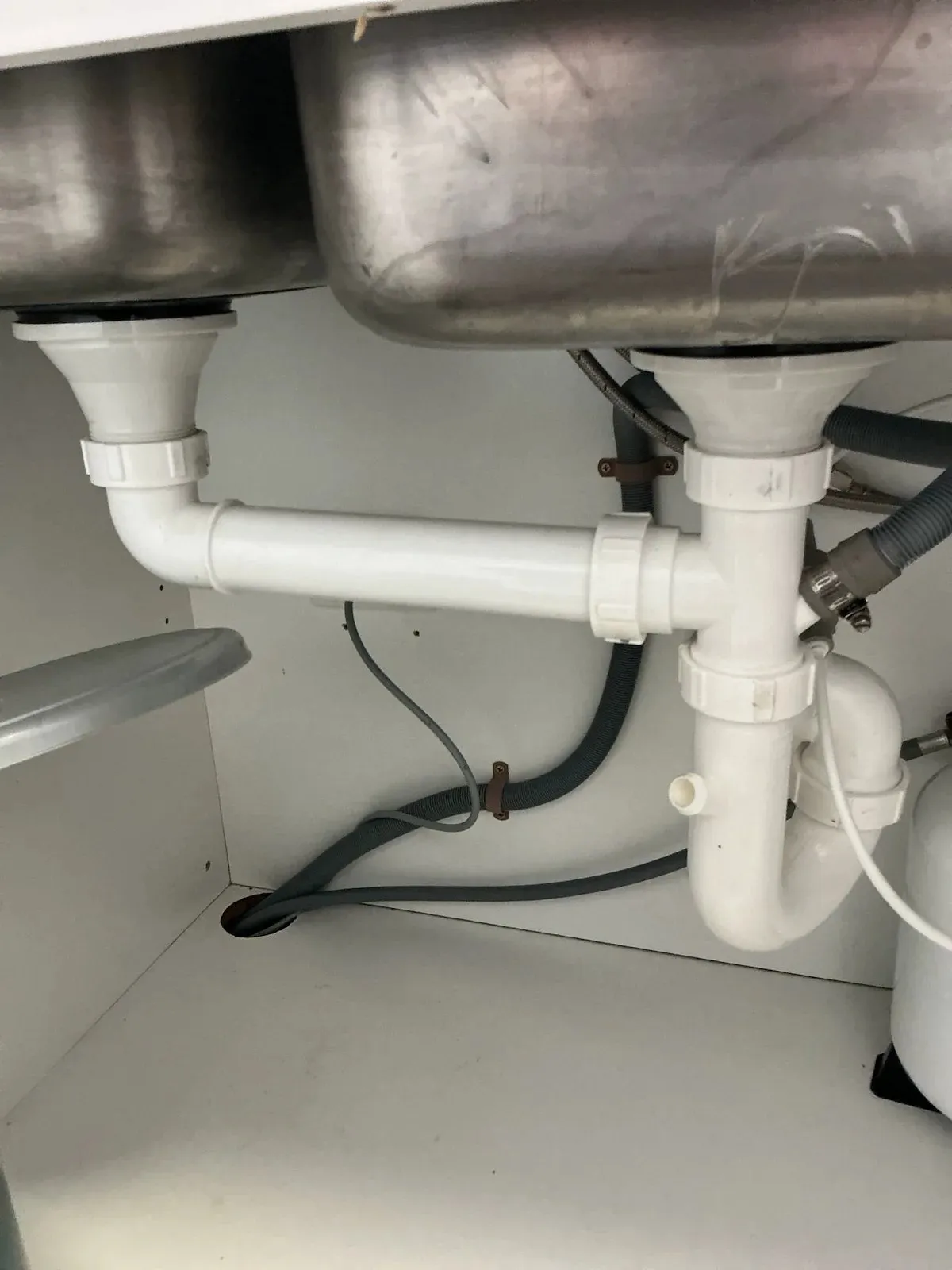 Kitchen sink waste pipes under the bench
