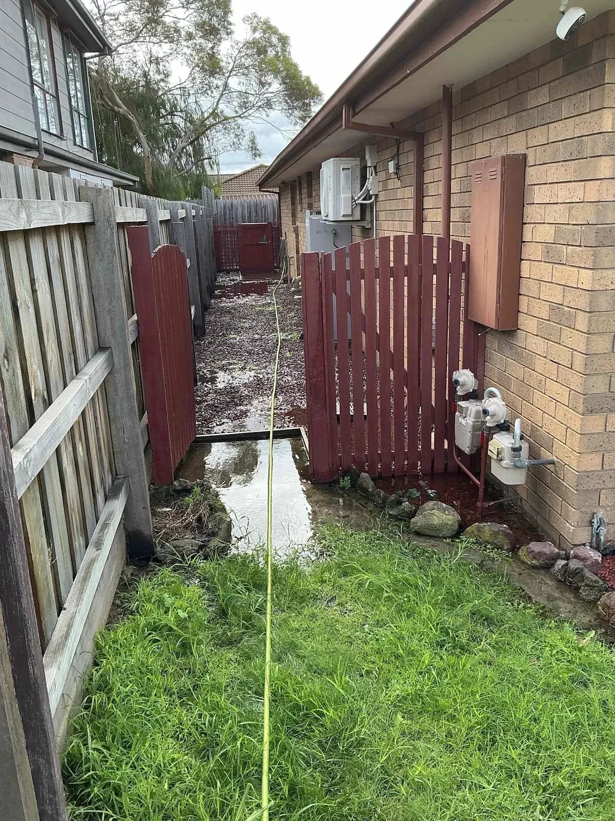 Water pooling down the side of the house