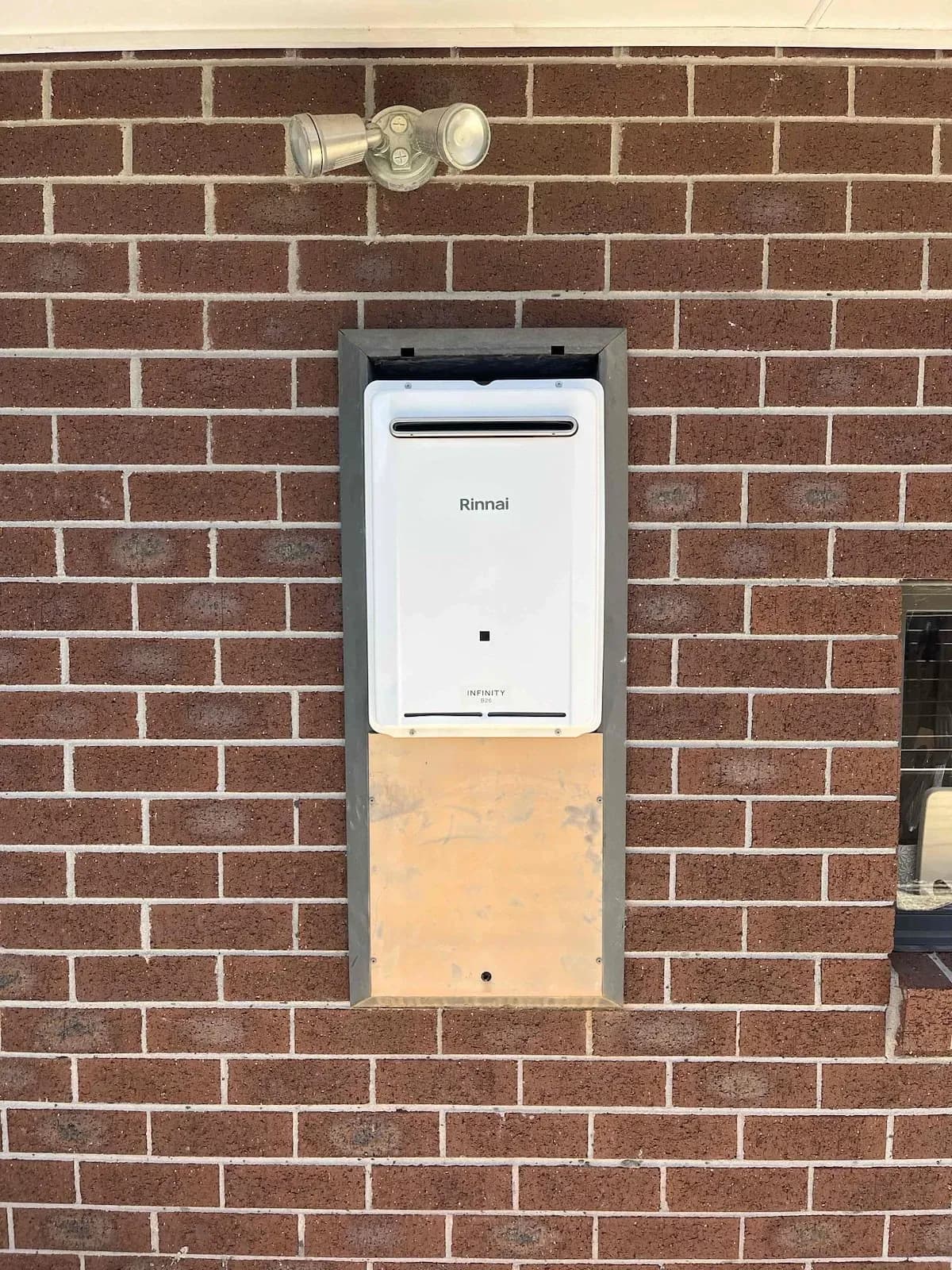 New continuous flow hot water unit set into a brick wall recess