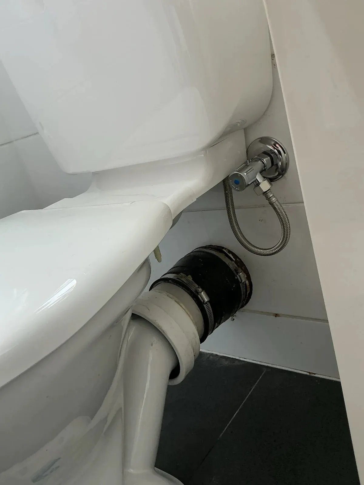 New pan connector and hose fitted to the toilet
