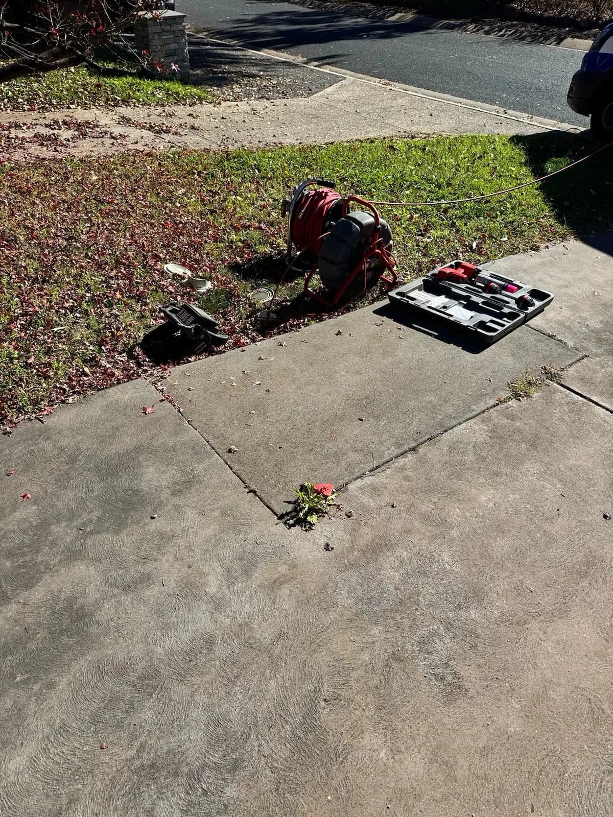 Drain cleaning gear set up on a front yard in Chapman