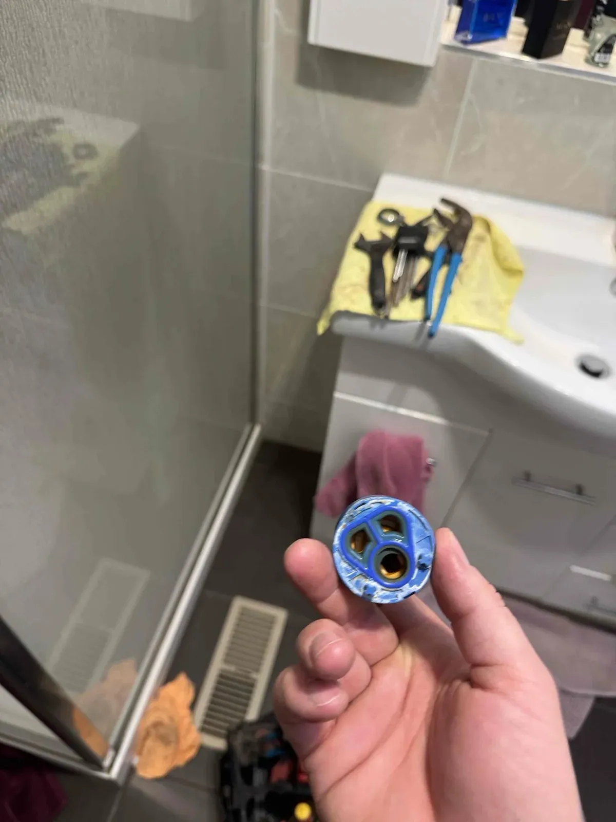 Worn shower mixer cartridge removed