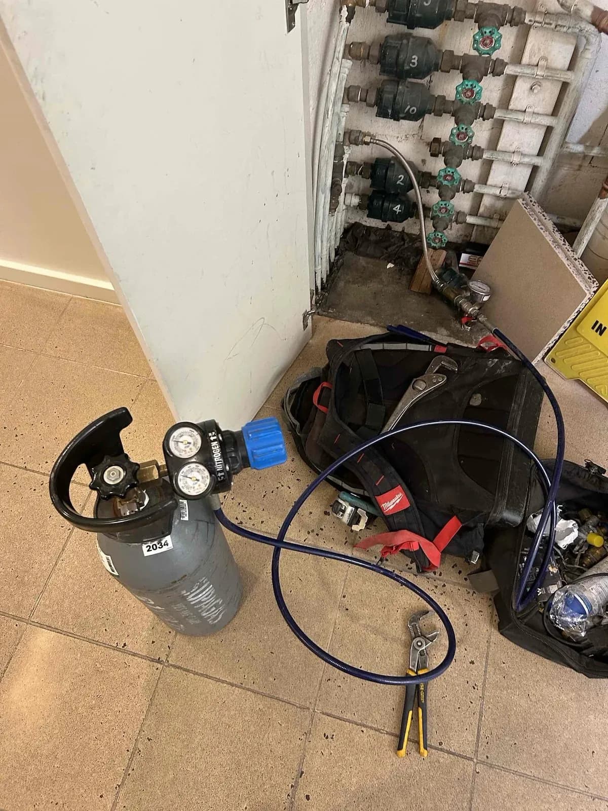 Leak testing gear set up at the apartment water meters