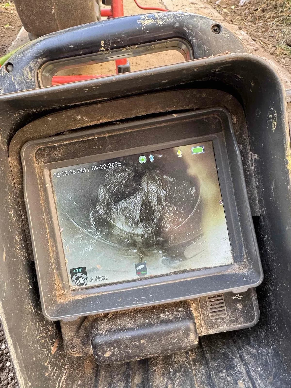 Drain camera screen showing inside the cracked pipe