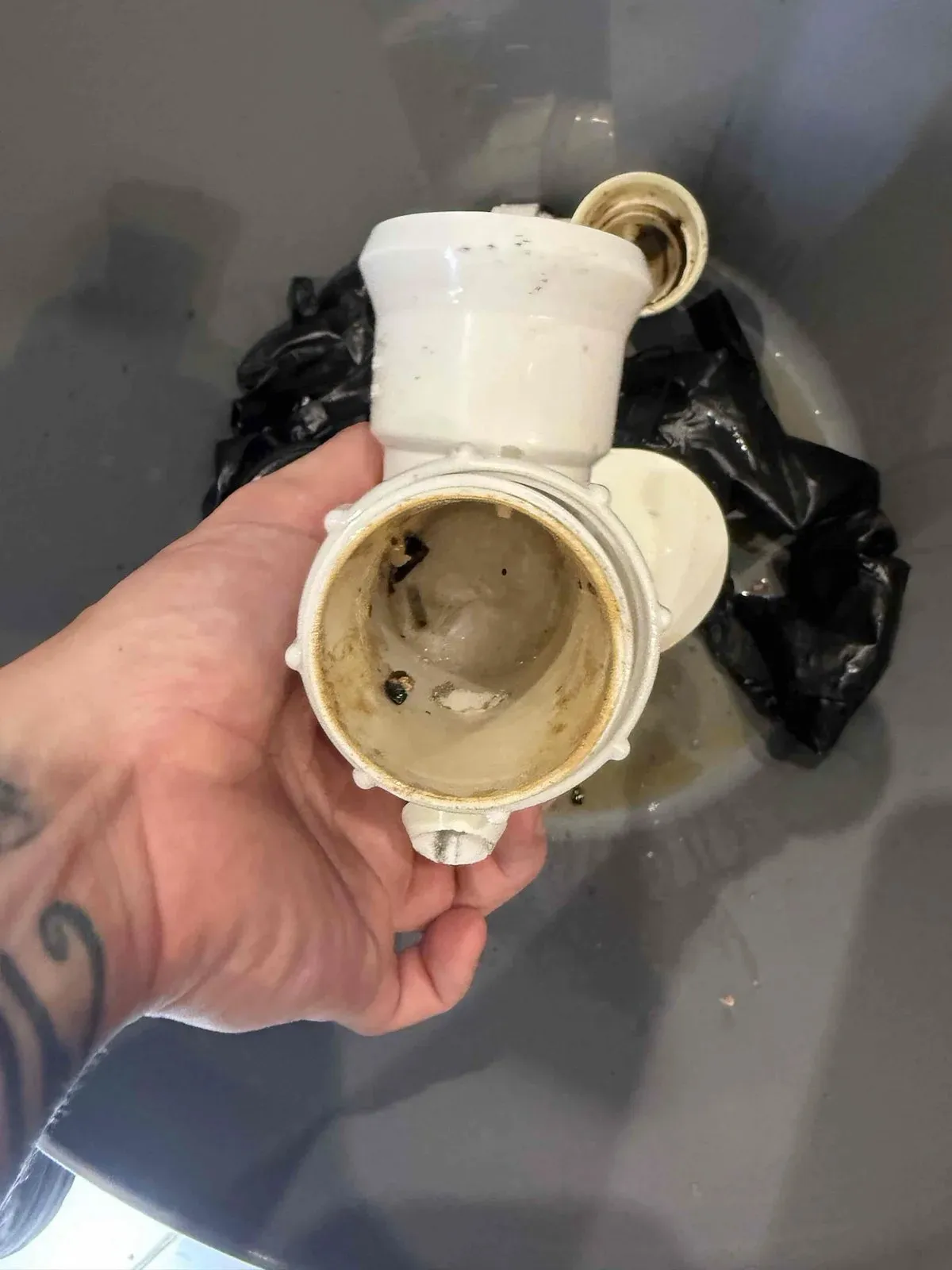 Sink trap removed with melted plastic caught inside