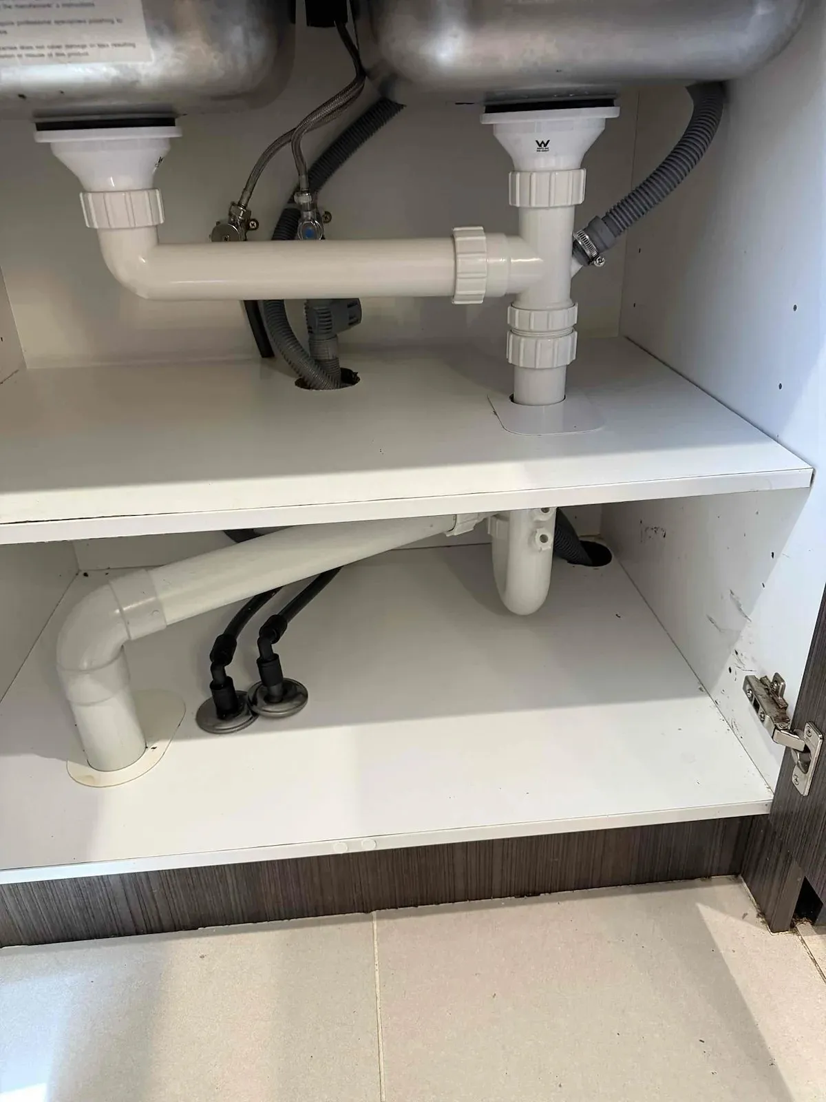 New sink waste and traps under the kitchen sink