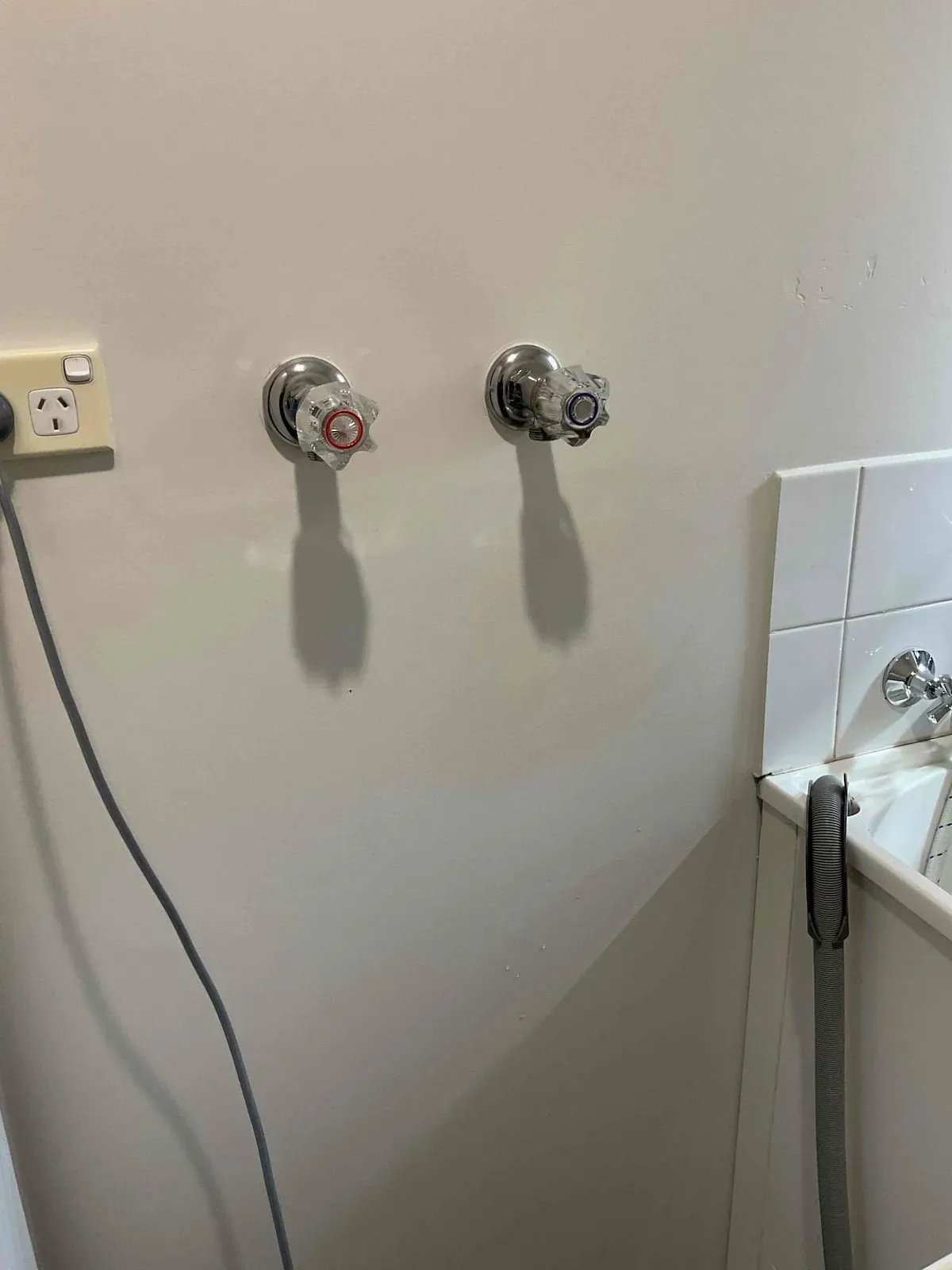 Old washing machine taps on the laundry wall