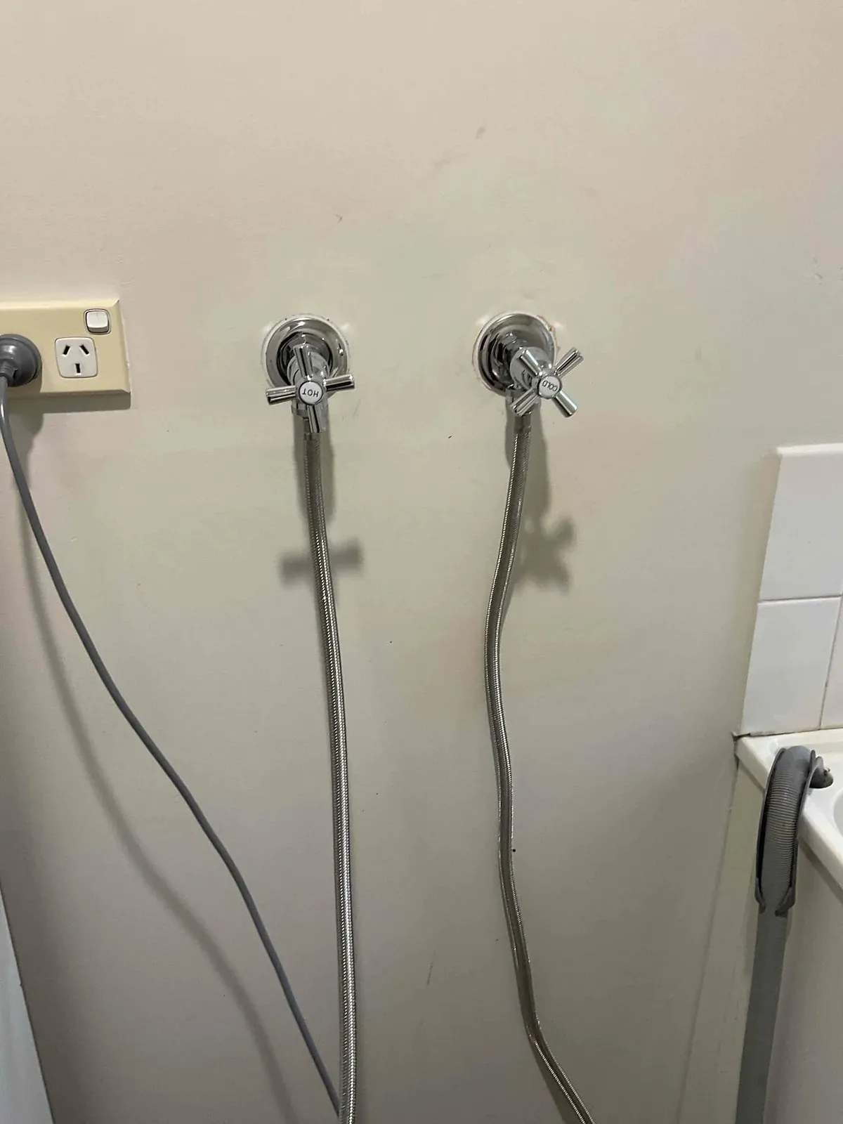 New washing machine taps with hoses connected
