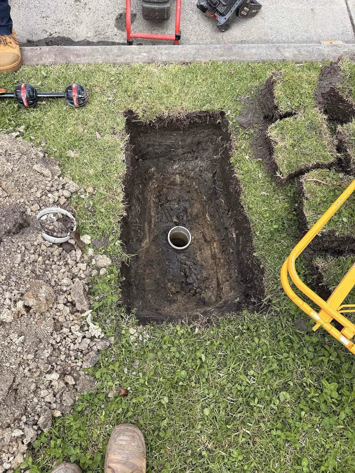 Lawn dug up to reach the stormwater pipe
