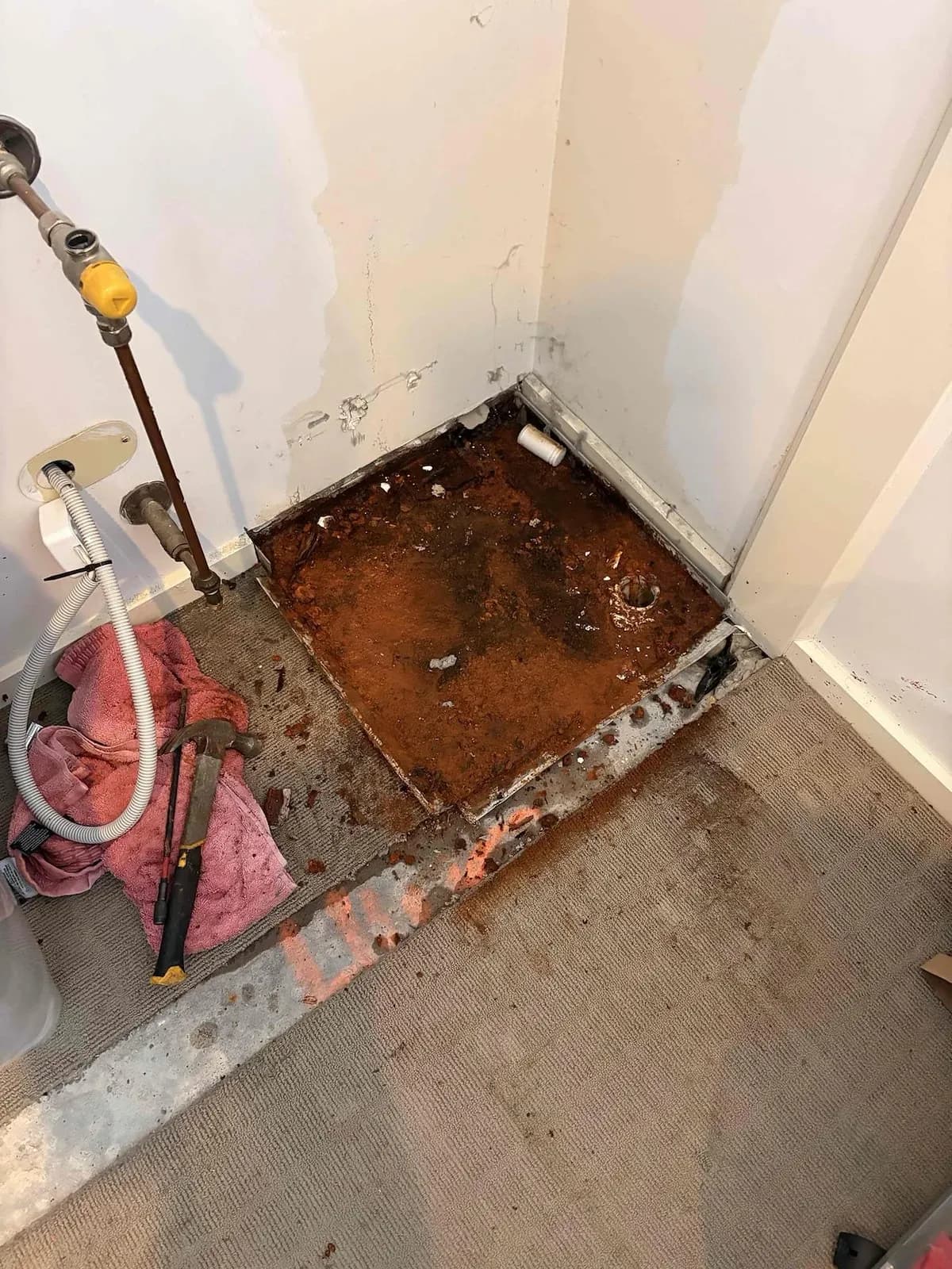 Water-damaged floor where the old unit stood