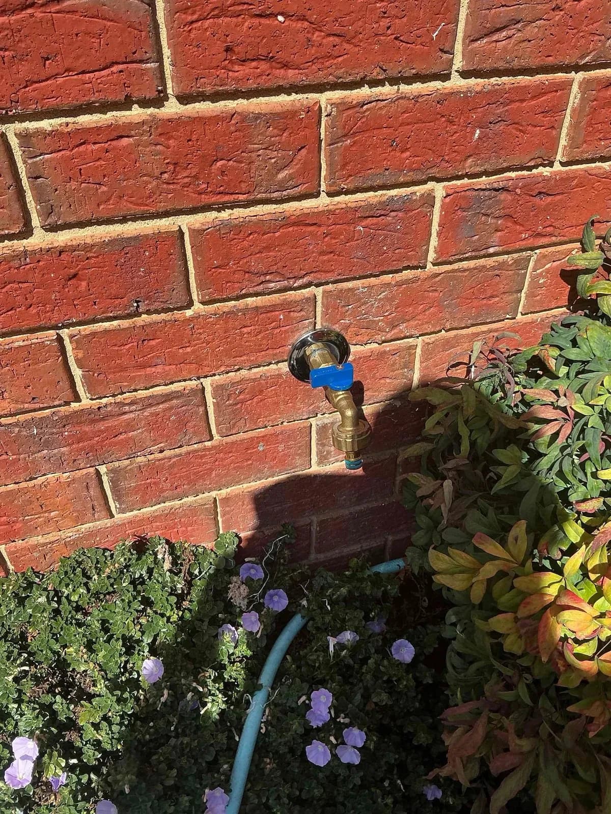 New garden tap fitted on the brick wall