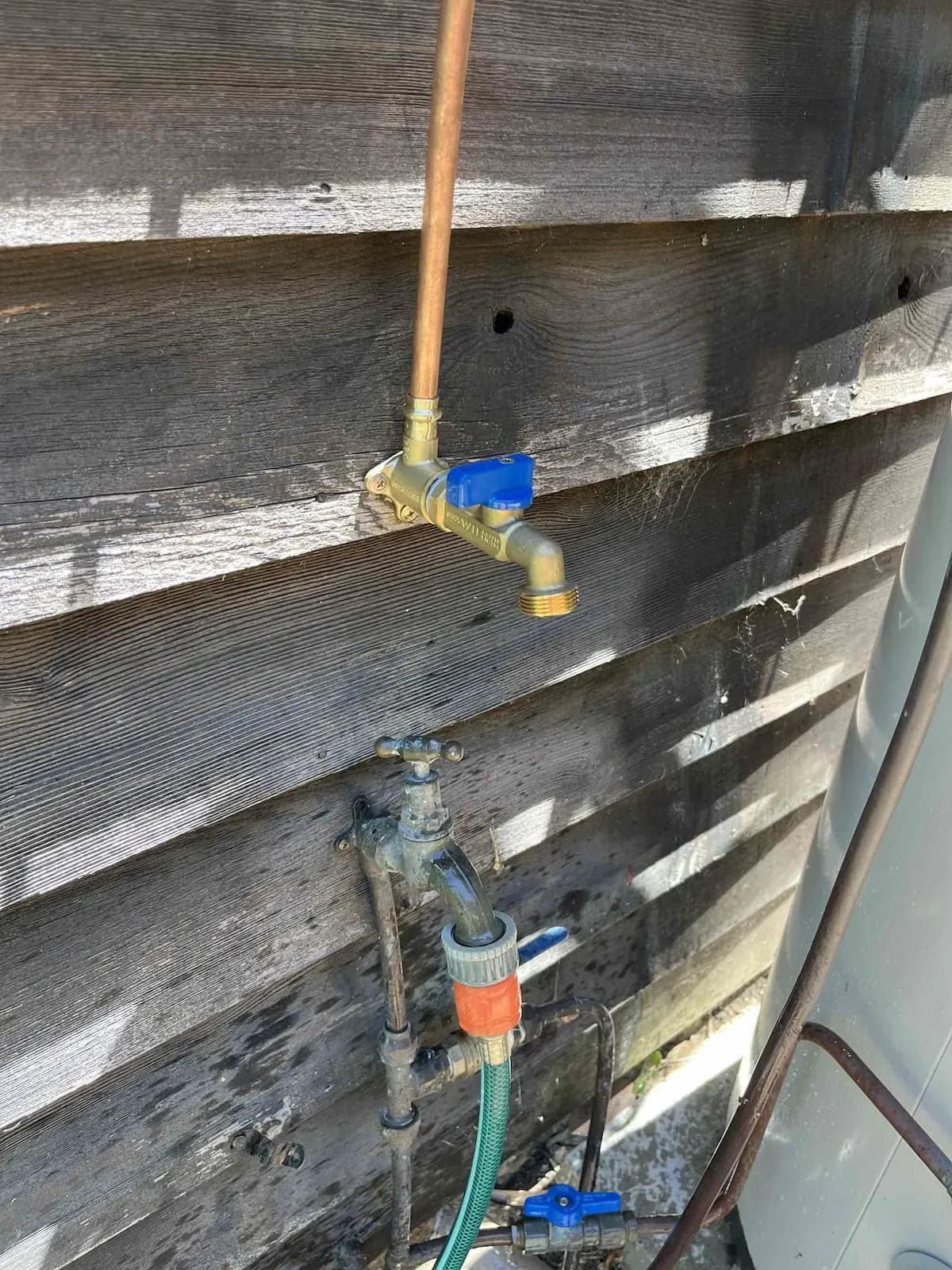New outside tap fitted on the weatherboard wall