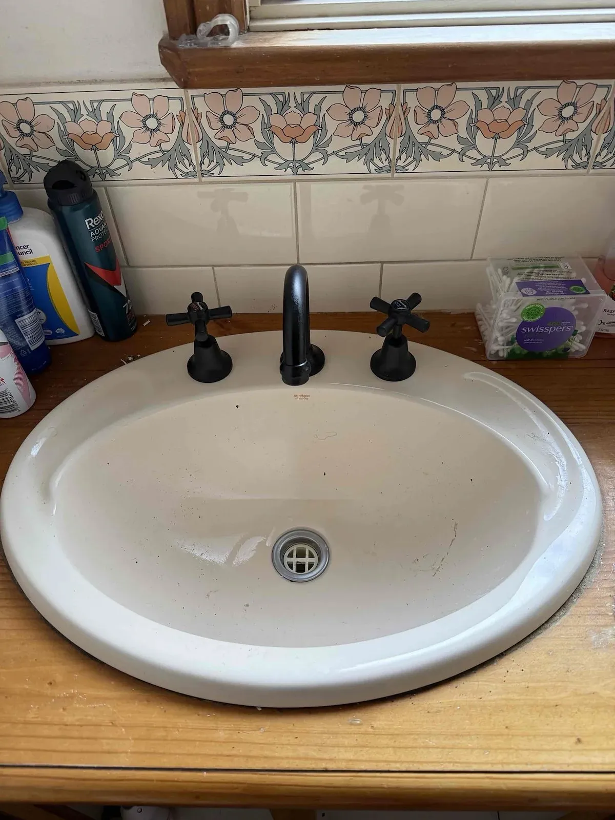 Bathroom basin with new black tapware