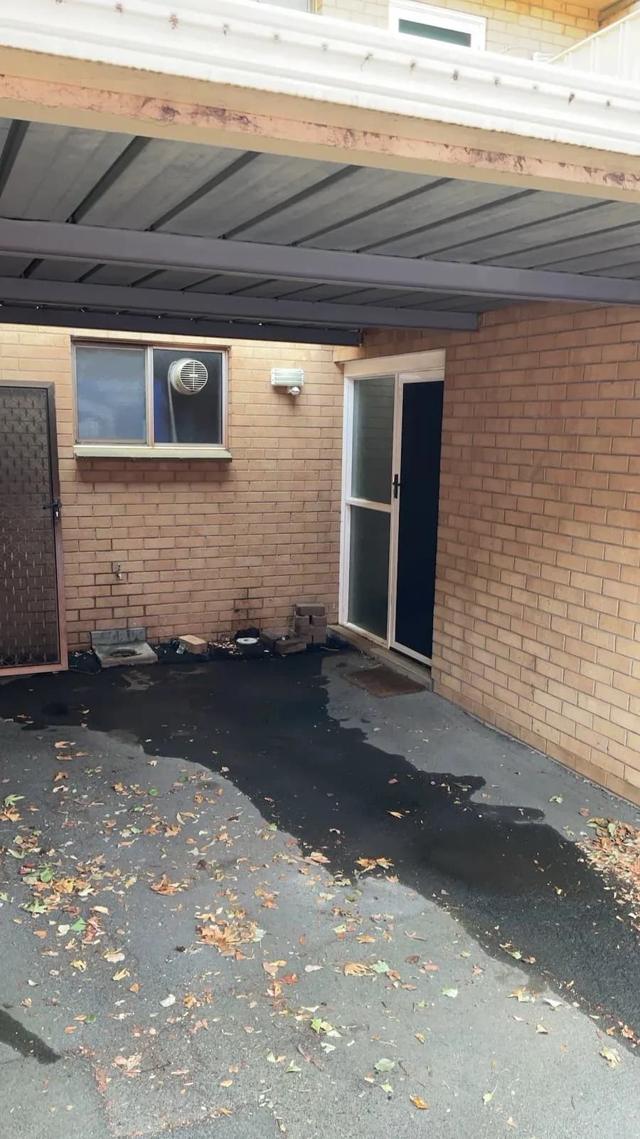 Carport area where the root-blocked sewer was cleared in Farrer