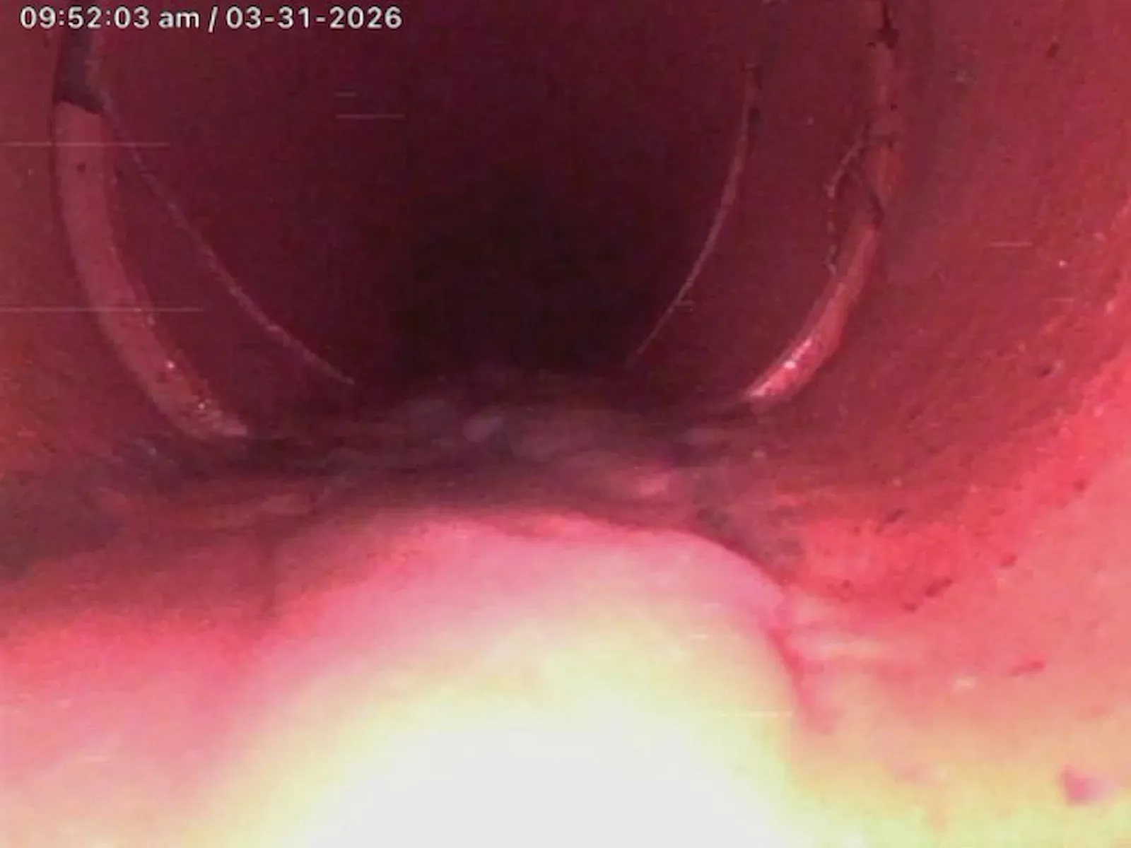 Drain camera view of the clear, repaired sewer pipe