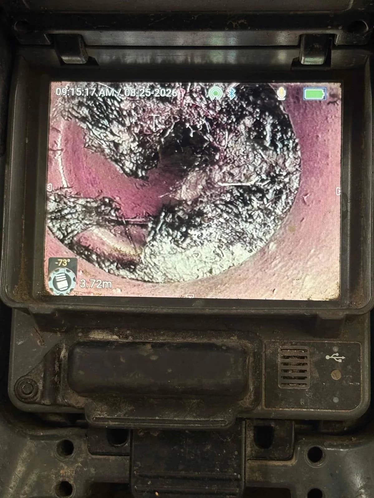 Drain camera view of tree roots inside the toilet drain