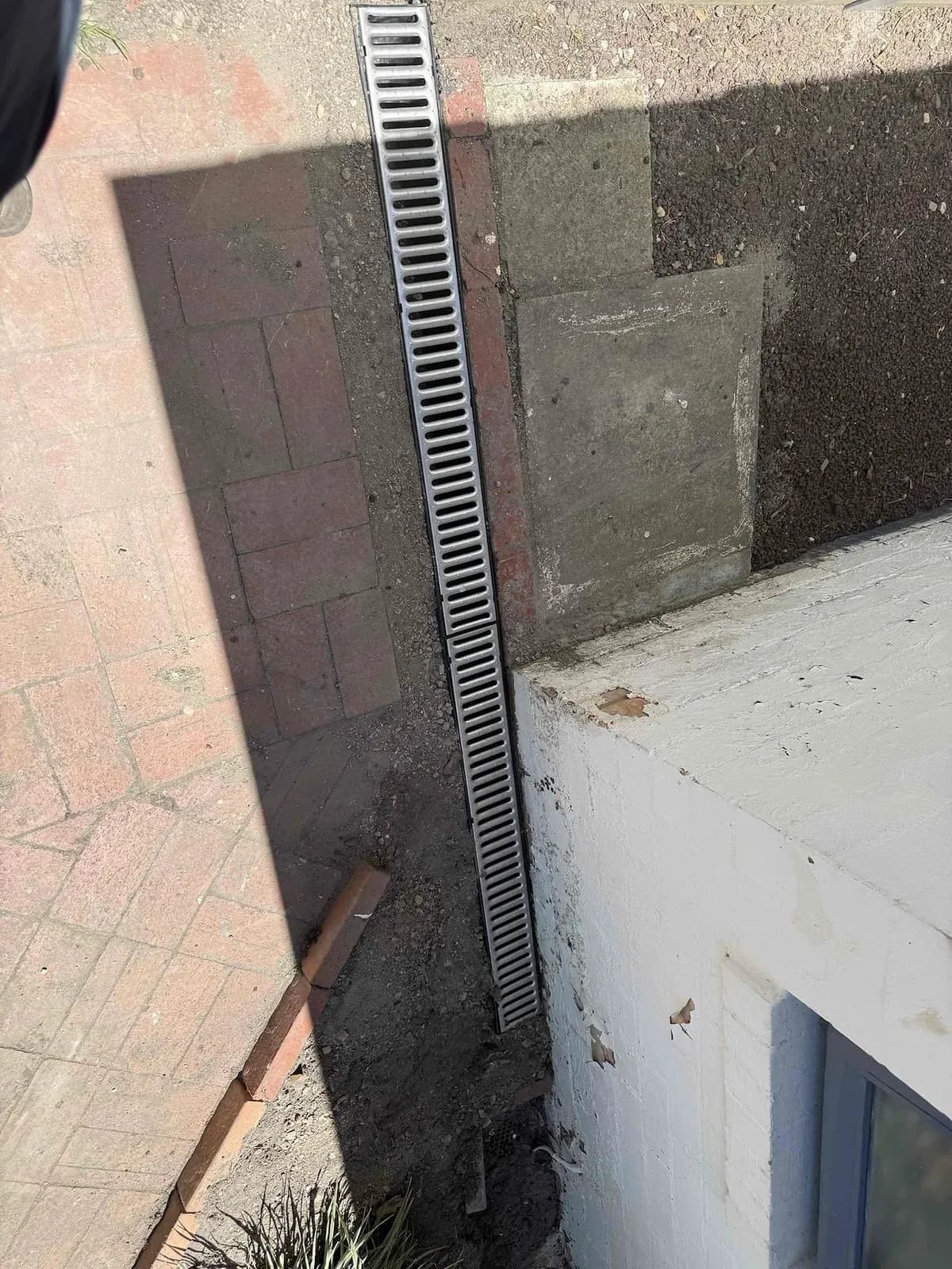 New strip grate installed to catch storm runoff