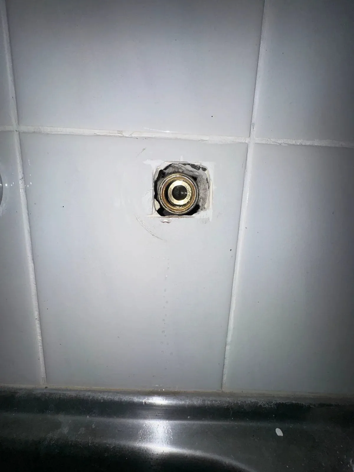 Tap body opened up in the tiled wall for a rebuild
