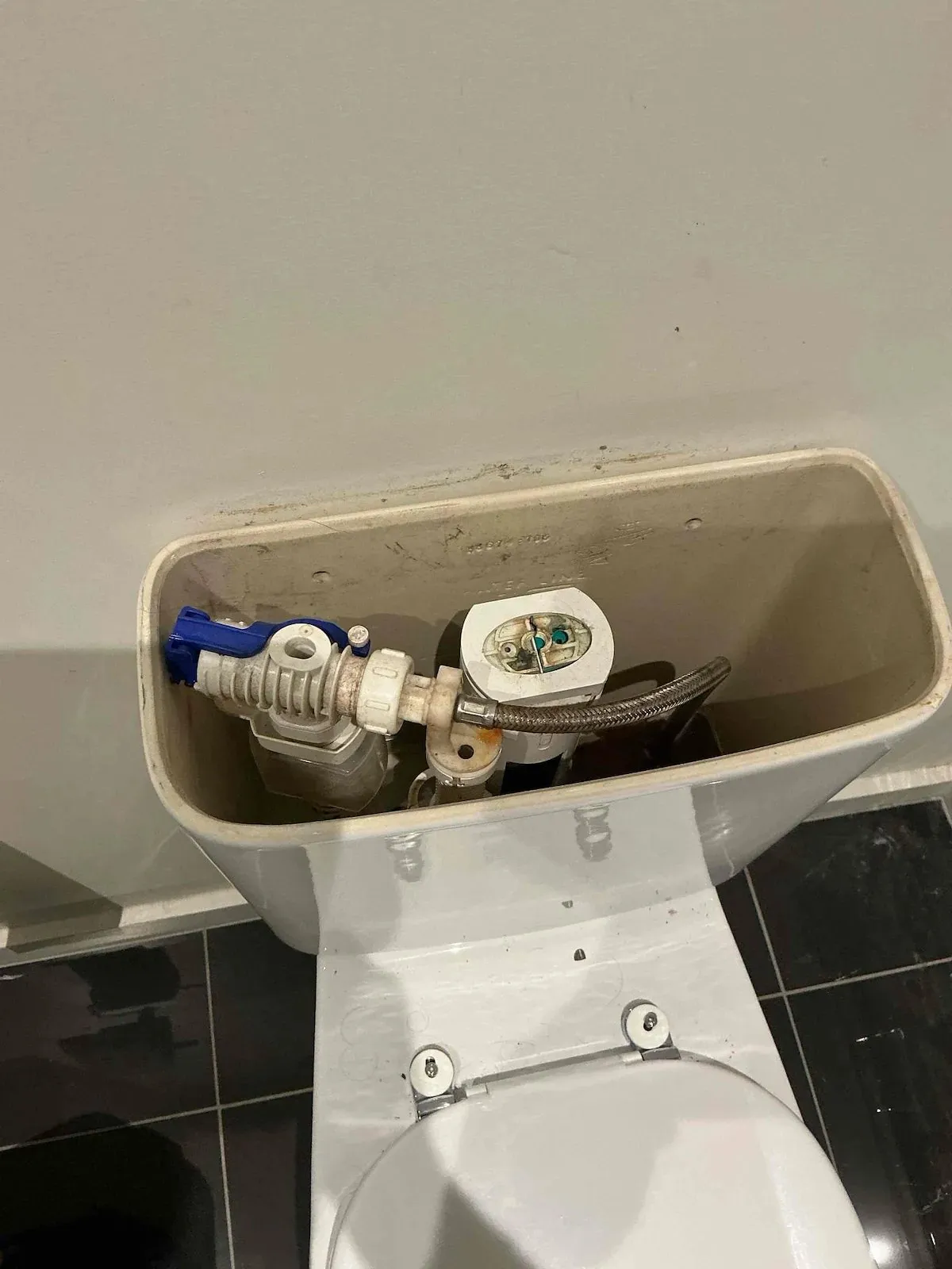 Toilet cistern fitted with new inlet and outlet valves