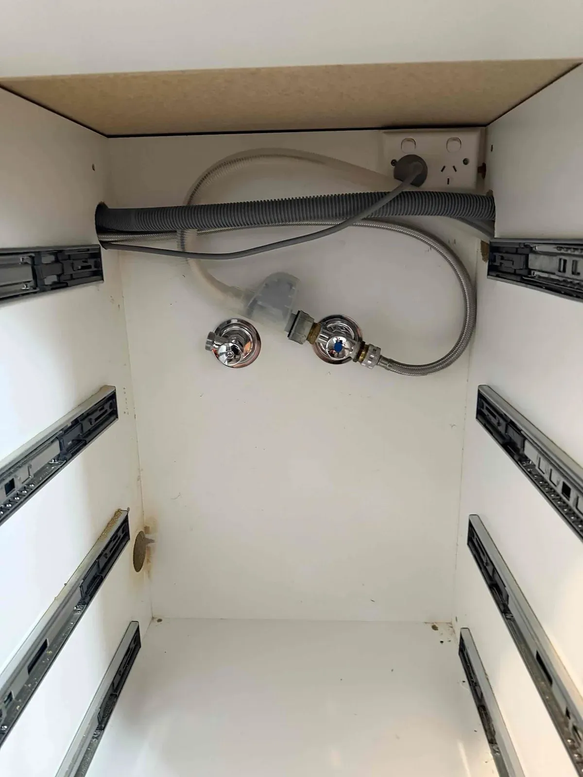 Kitchen cabinet with the new washing machine hose and connections