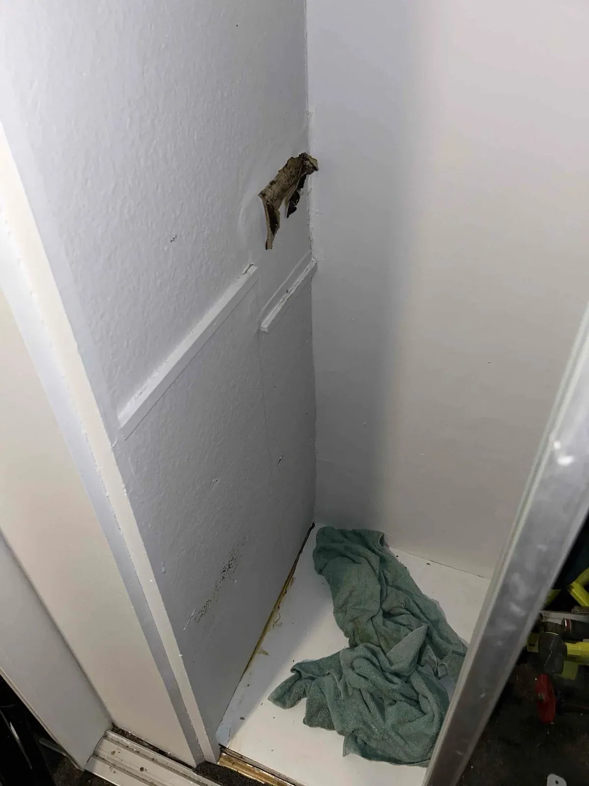 Wall opened up in the wardrobe to trace the leak