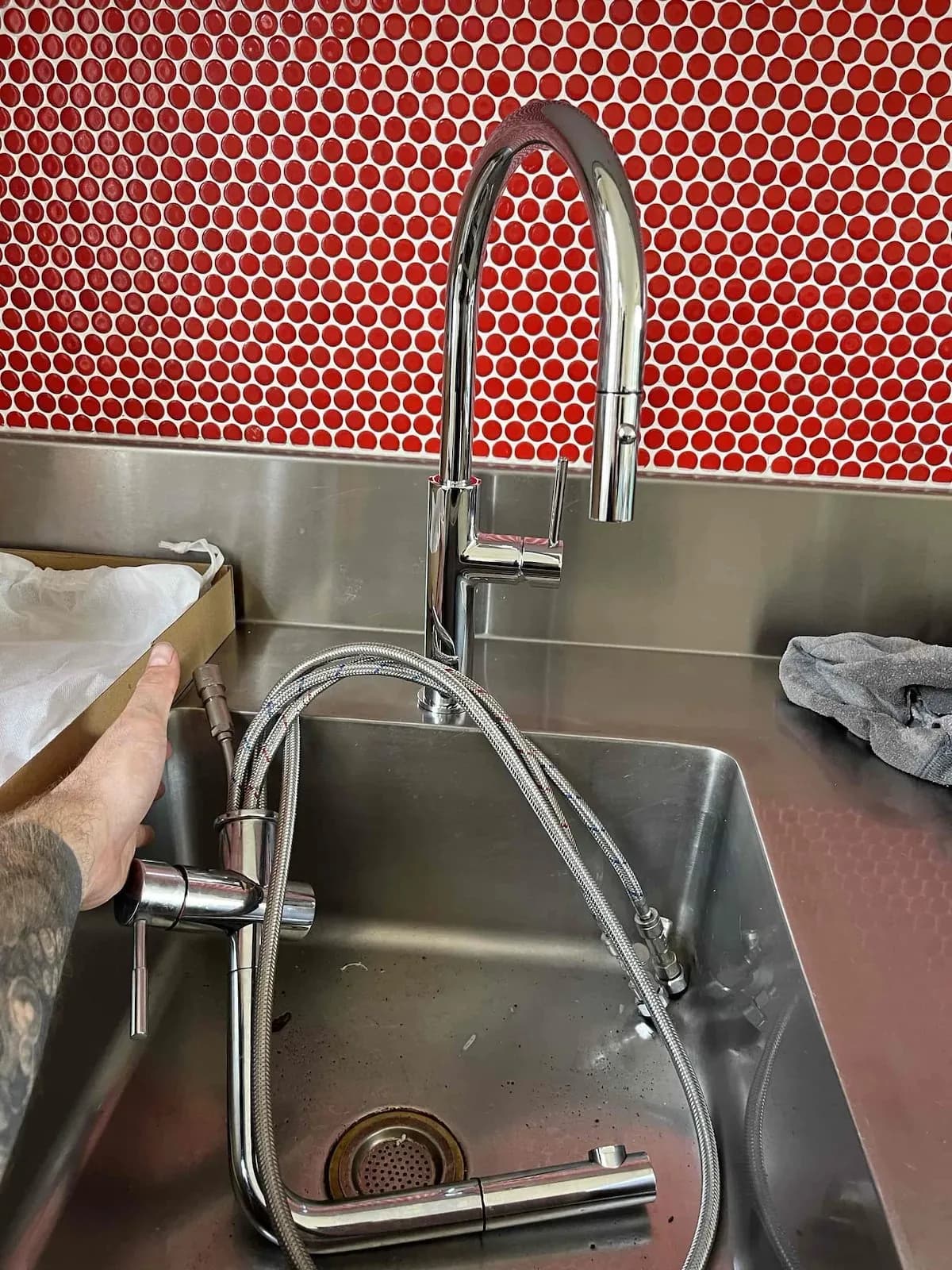 New pull-down kitchen mixer over a stainless sink