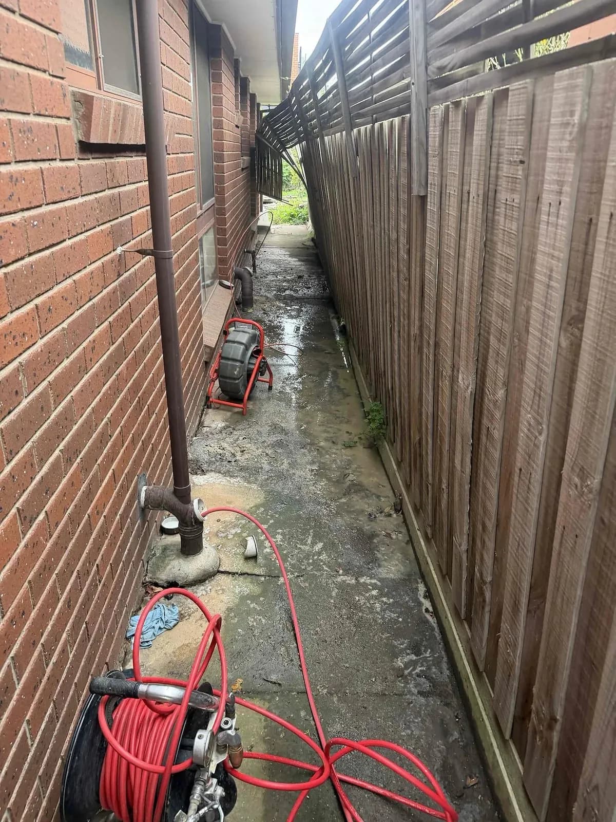 Drain machine set up at the side of the house