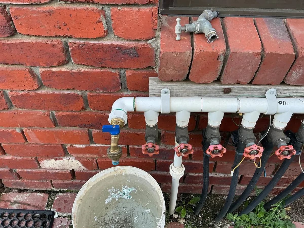 Repaired water pipework and taps on the outside wall