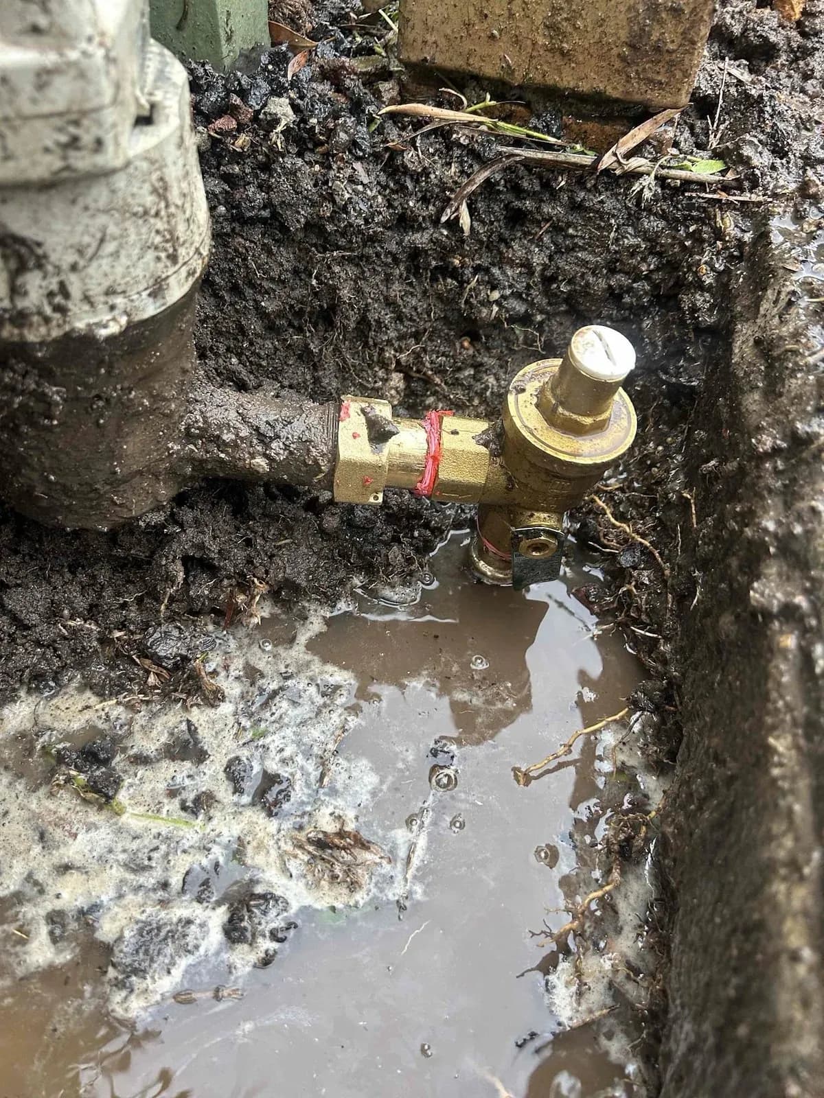 Burst water pipe dug out beside the meter