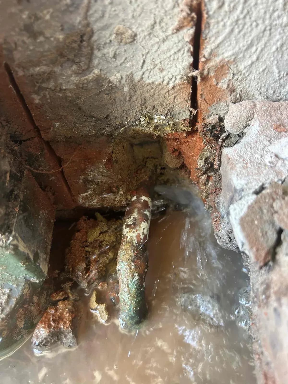 Corroded copper pipe leaking under the concrete