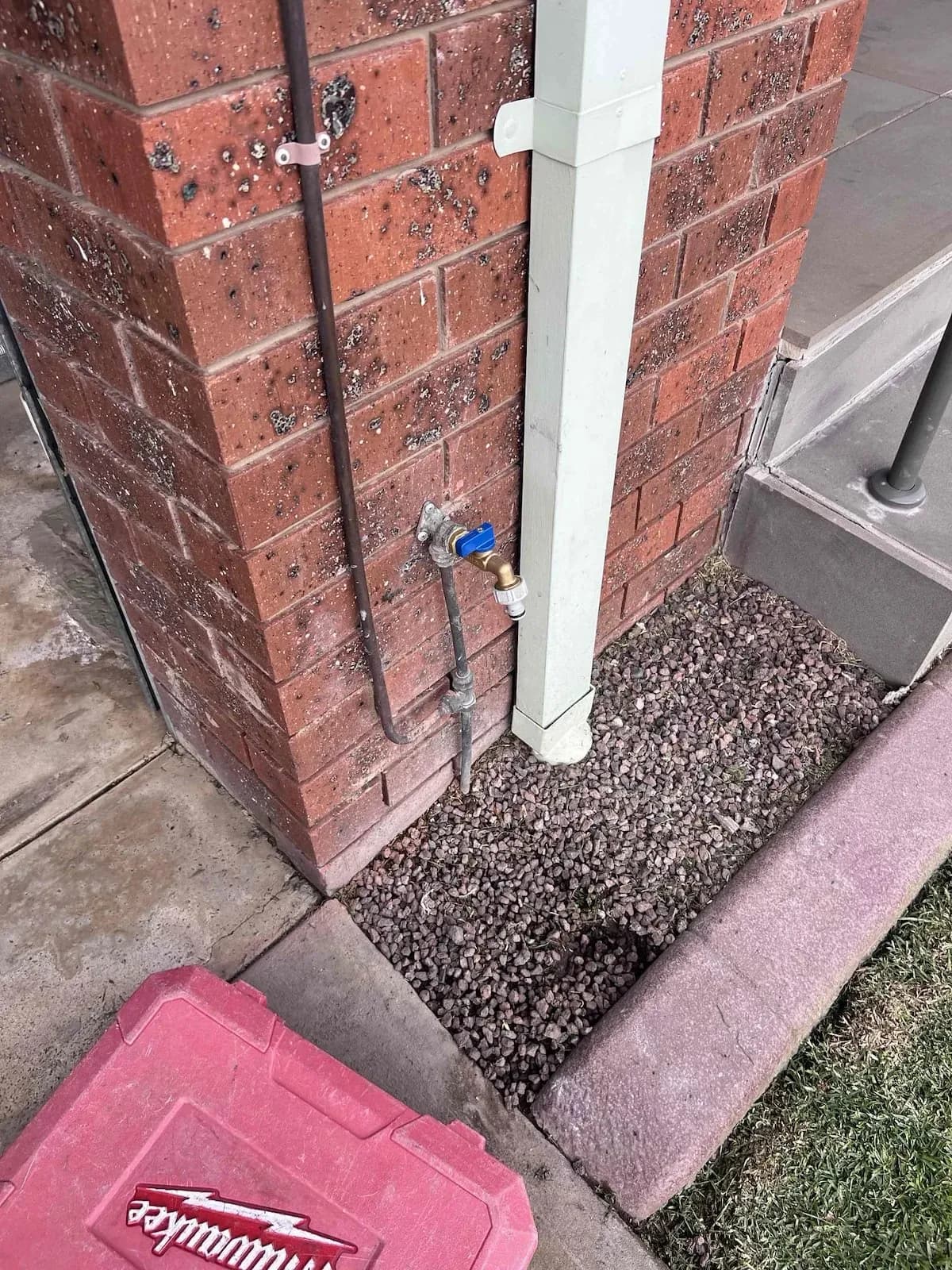 Outside tap and pipework beside a downpipe