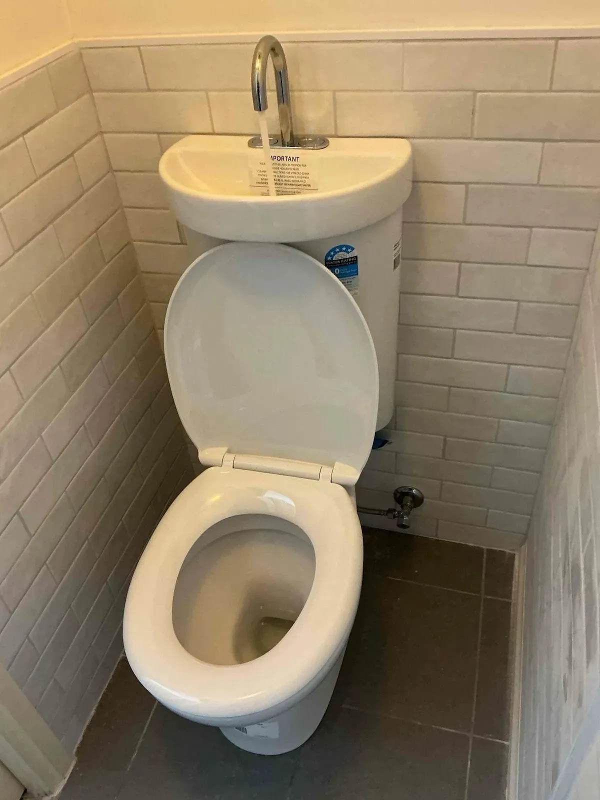 New toilet with basin top installed