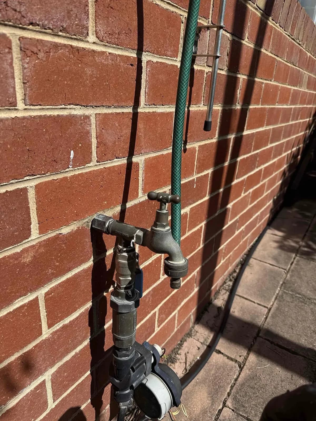 Water meter and garden tap on the outside wall