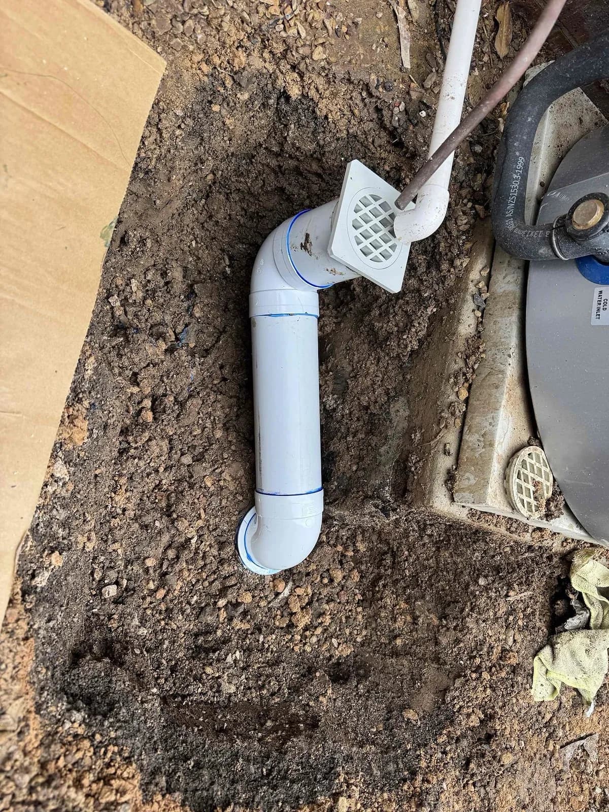Repaired stormwater connection beside the hot water unit