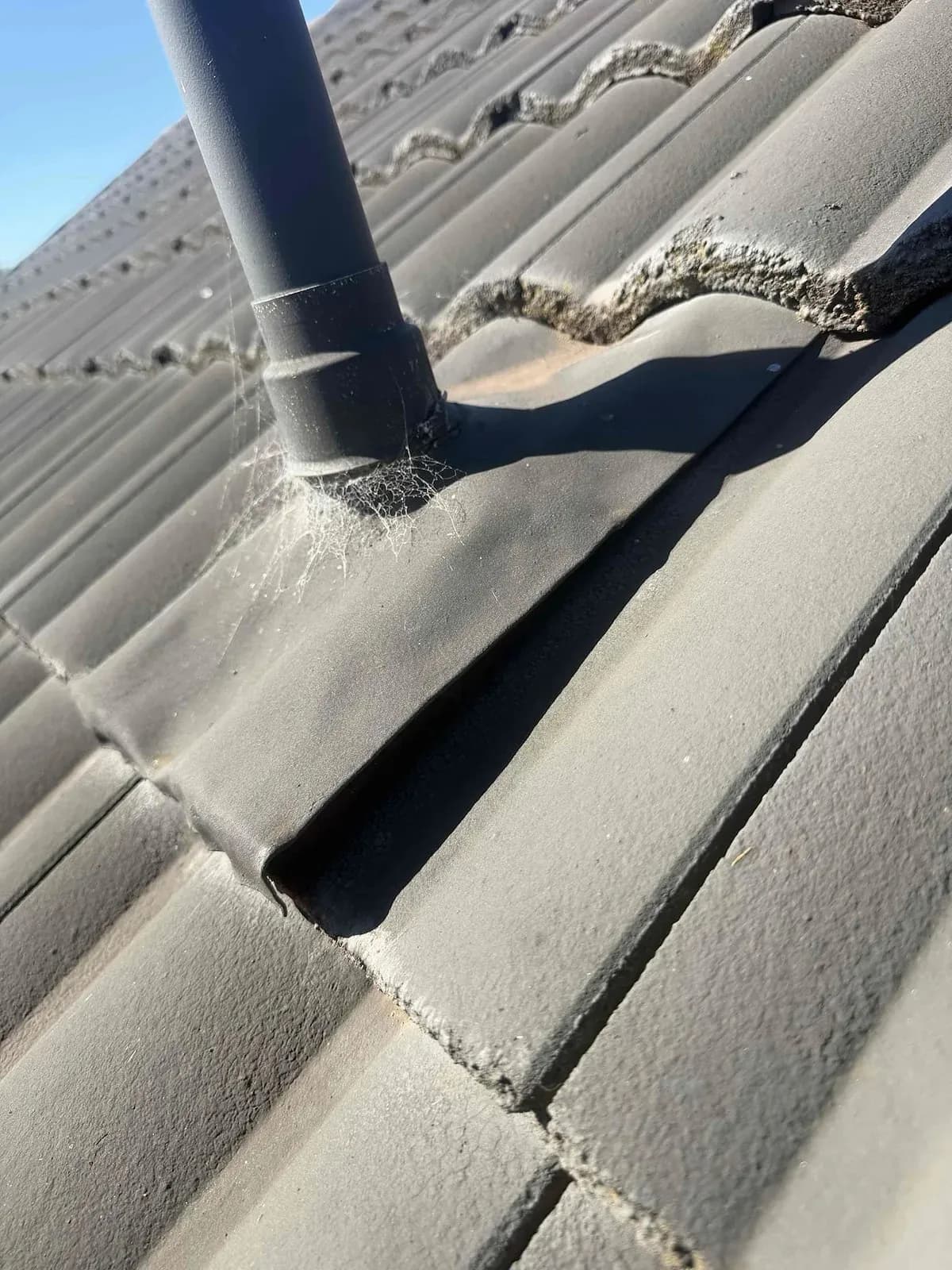 Lifted lead flashing around a roof vent pipe