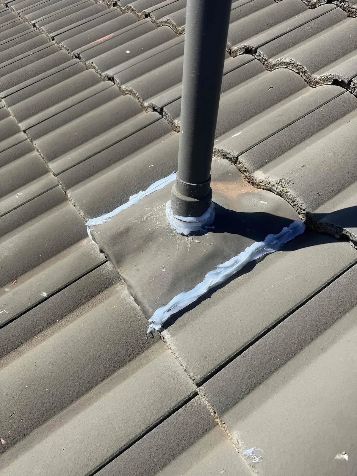 Flashing flattened and sealed around the vent pipe
