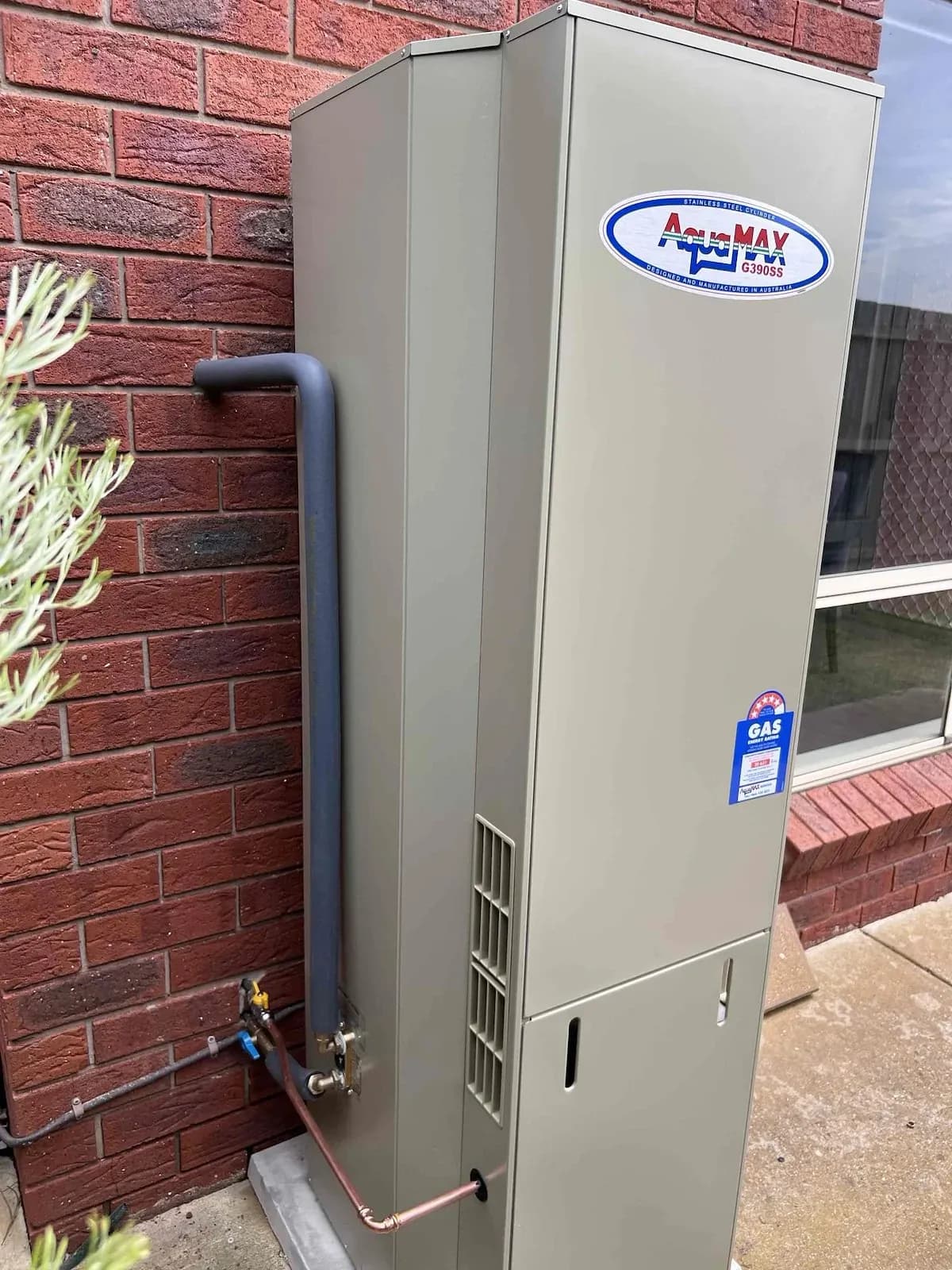 New gas hot water system on a brick wall