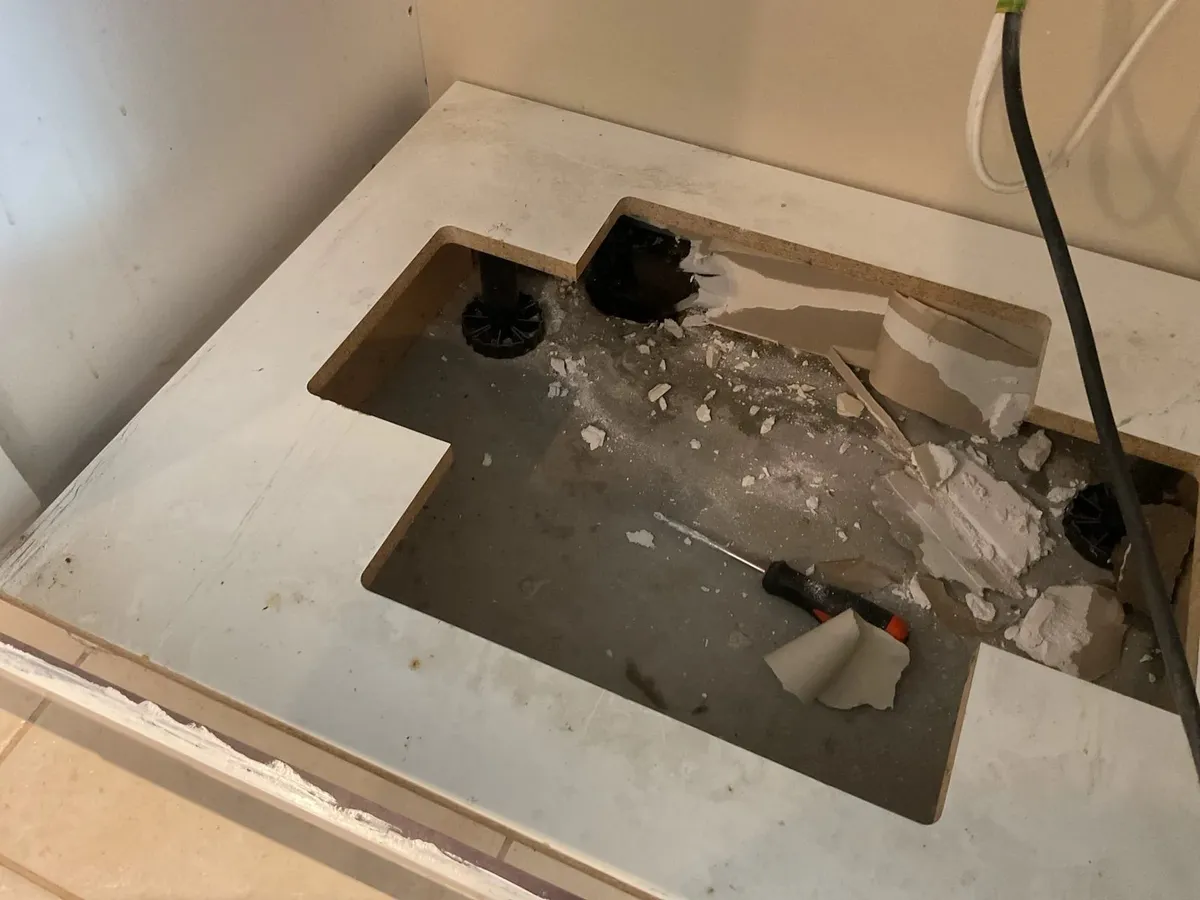 Sink cabinet floor opened up to trace the leak
